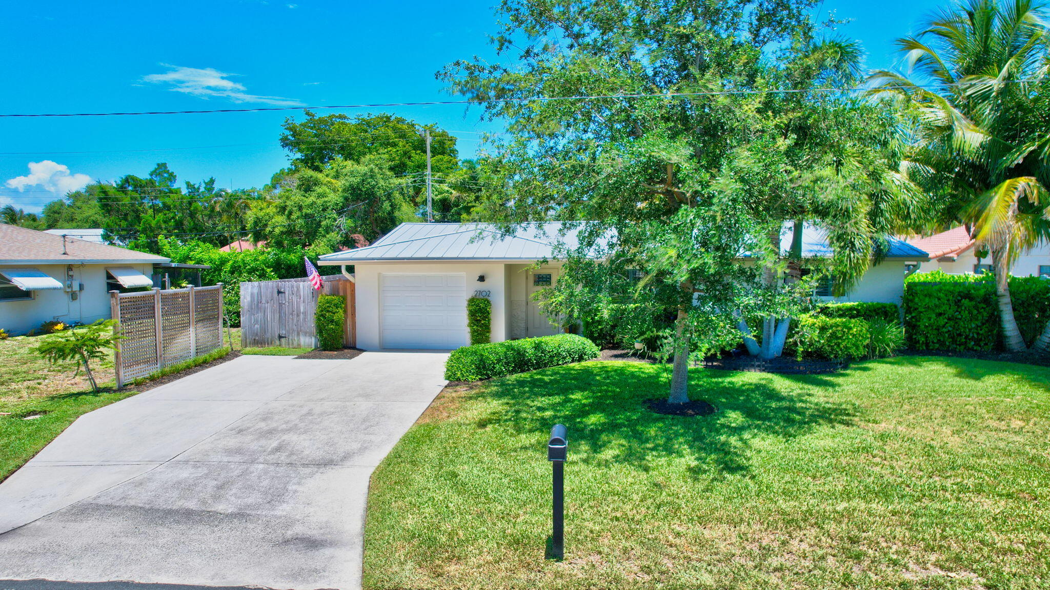 2702 Southwest 6th Street Boynton Beach, FL 33435 - Photo 42 of 49 a front view of a house with a yard and trees