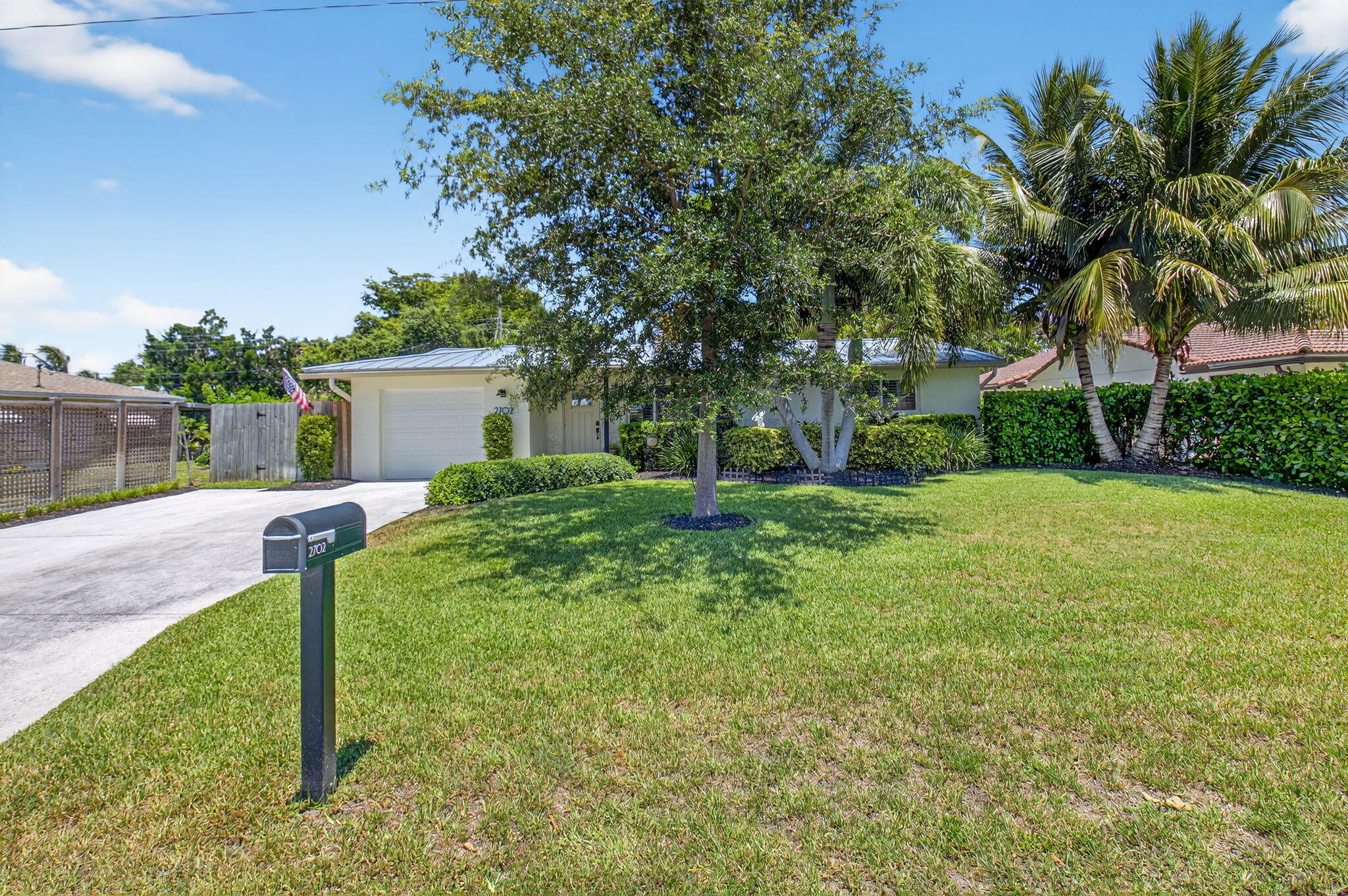2702 Southwest 6th Street Boynton Beach, FL 33435 - Photo 47 of 49 a front view of a house with garden and trees