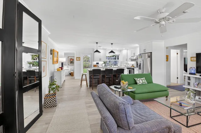 a living room with furniture and a chandelier