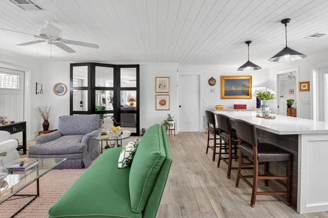 a living room with furniture dining table and a chandelier