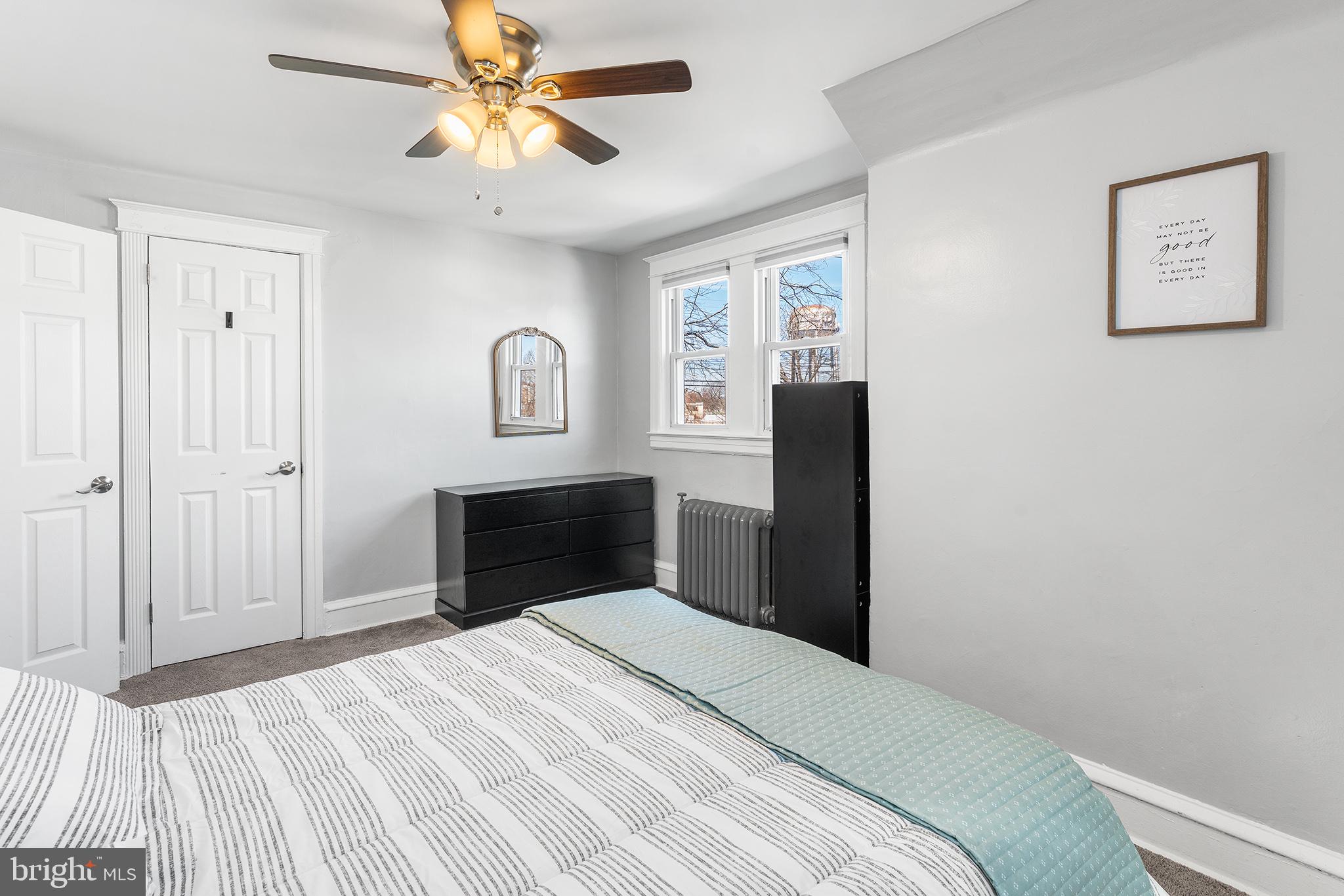 424 Cypress Street Lansdowne, PA 19050 - Photo 21 of 32 a bedroom with a bed and a chandelier