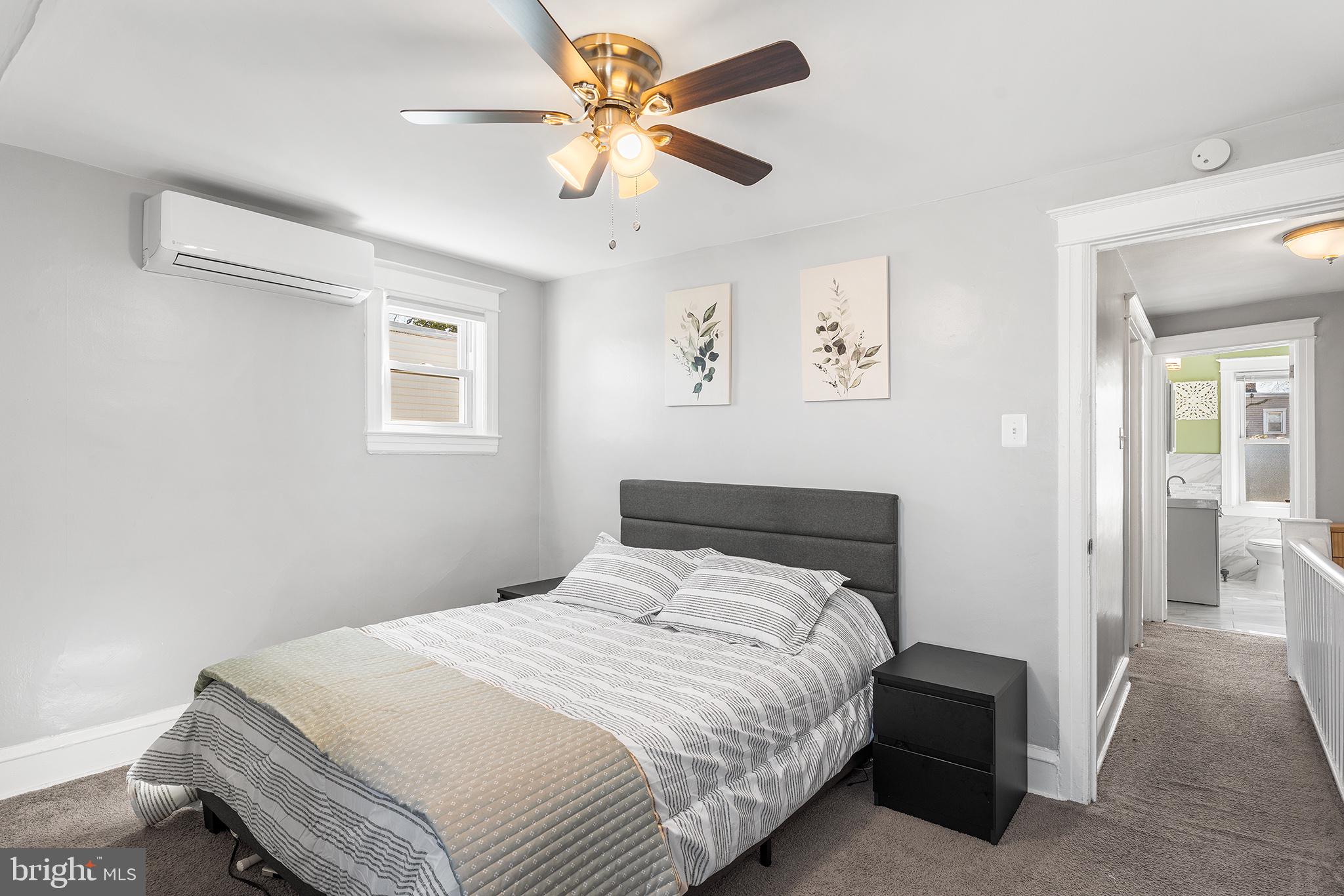 424 Cypress Street Lansdowne, PA 19050 - Photo 23 of 32 a bedroom with a bed and a chandelier