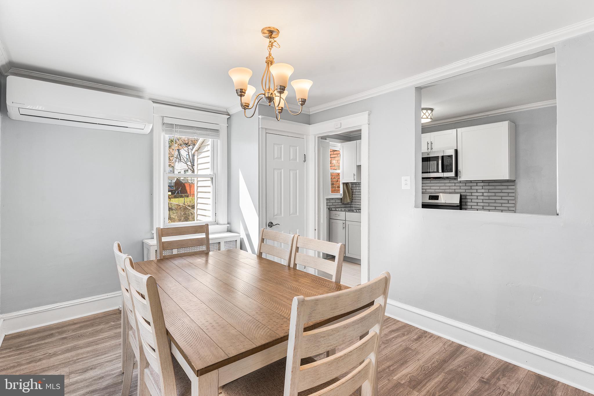 424 Cypress Street Lansdowne, PA 19050 - Photo 8 of 32 a dining room with wooden floor and chandelier
