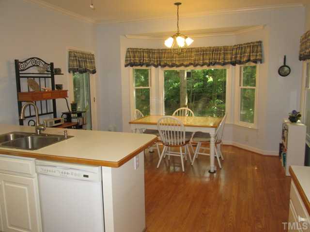 6016 Bur Trail Raleigh, NC 27616 - Photo 14 of 25 The eat in kitchen also features hardwood floors that run from the kitchen area into the breakfast room. Kitchen also has an eat at bar, dishwasher, pantry, built in microwave, lots of crown molding throughout! Great views out back!
