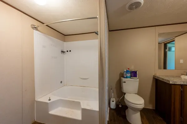 a view of a room with wooden floor and window
