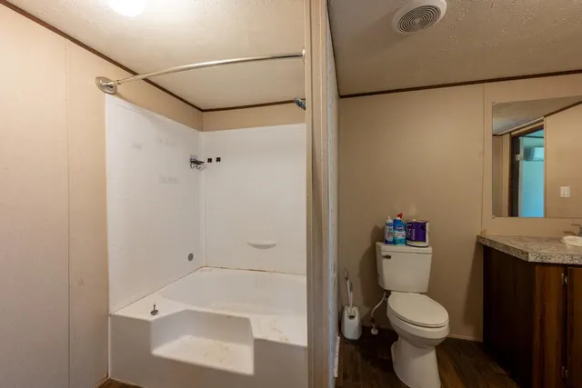 a view of a room with wooden floor and window