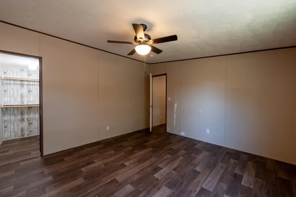 a view of an empty room with wooden floor