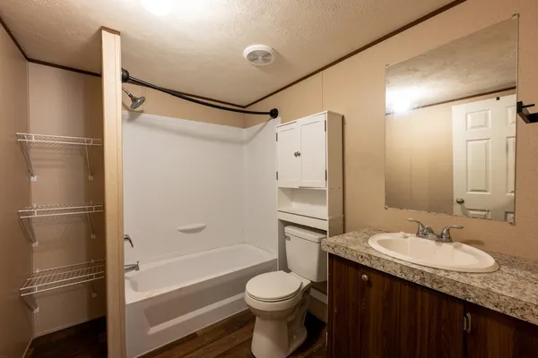 a view of wooden floor and chandelier fan in an empty room