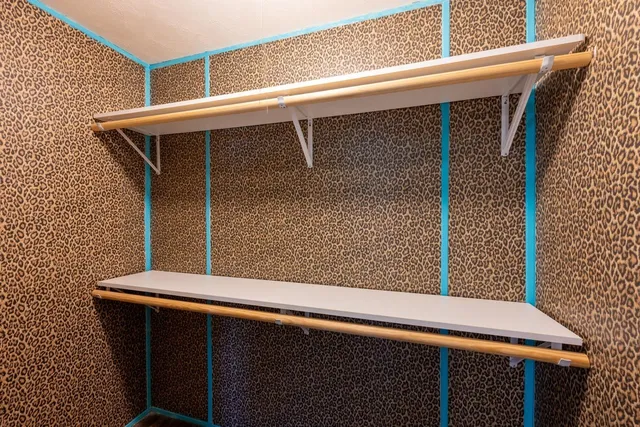 an aerial view of residential house with outdoor space and trees all around