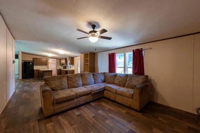 a kitchen with a sink a refrigerator and wooden floor