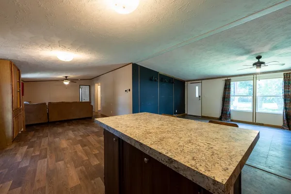 a view of a kitchen with a sink and a refrigerator