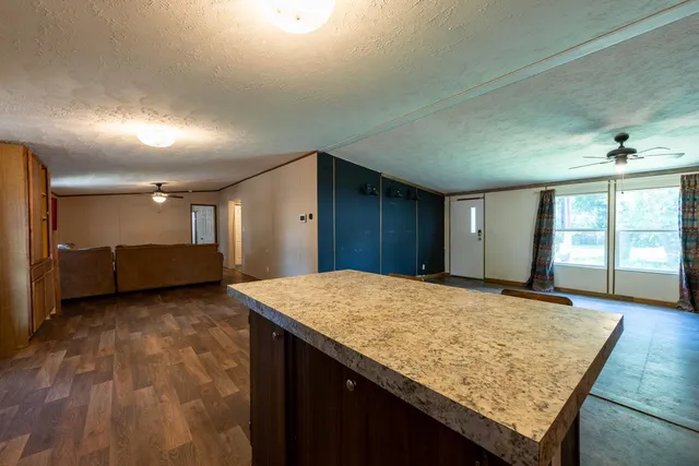 a view of a kitchen with a sink and a refrigerator