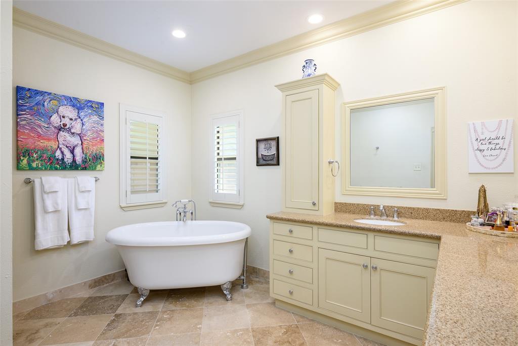 6822 Meadow Road Dallas, TX 75230 - Photo 14 of 35 Large Primary Bath. Footed Tub, Double Sinks. Travertine Floors. Updated light fixture.