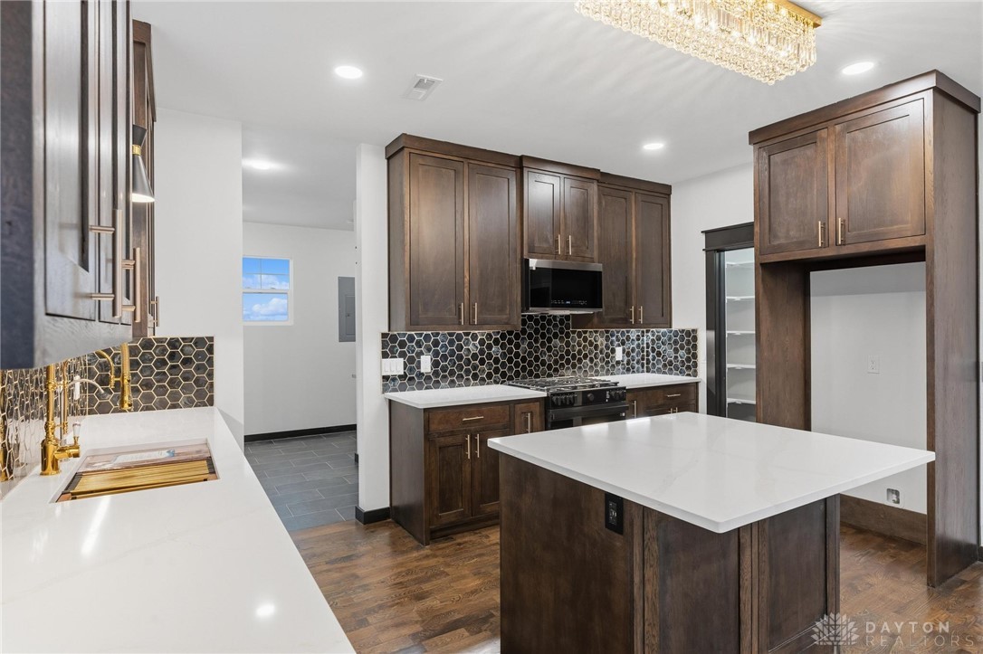 3509 South State Rte 72 Sabina, OH 45169 - Photo 12 of 44 This modern kitchen features a spacious island and sleek appliances, perfect for entertaining.