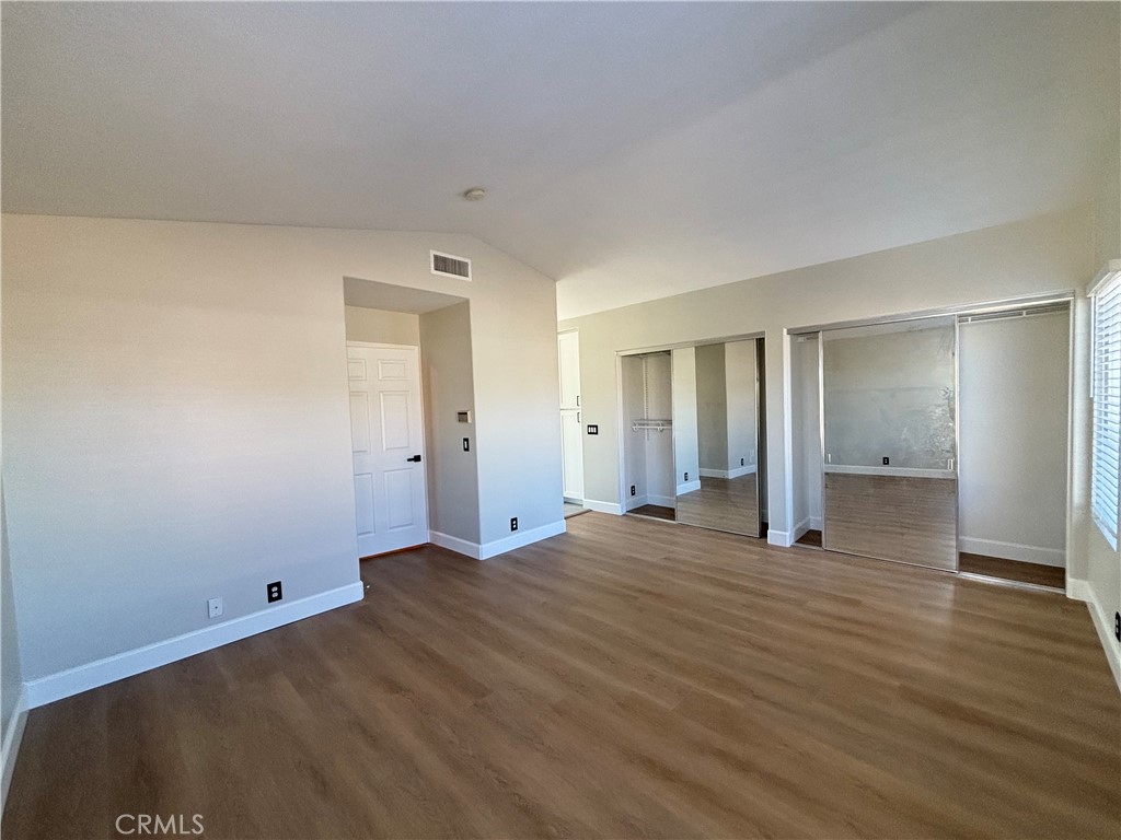15252 Riviera Lane La Mirada, CA 90638 - Photo 12 of 18 a view of an empty room with wooden floor and closet