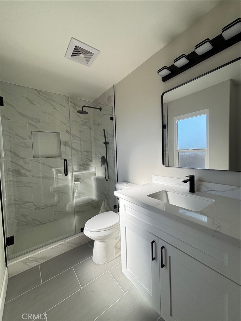 15252 Riviera Lane La Mirada, CA 90638 - Photo 13 of 18 a bathroom with a sink a toilet and shower