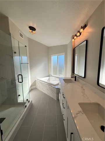 a bathroom with a tub sink and mirror
