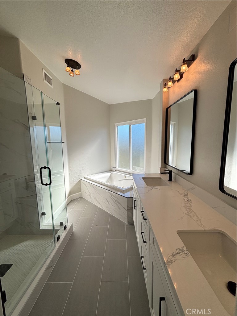 15252 Riviera Lane La Mirada, CA 90638 - Photo 14 of 18 a bathroom with a tub sink and mirror