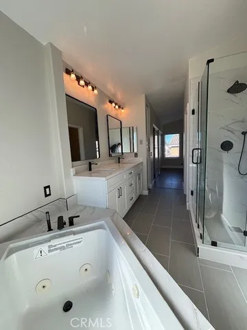a spacious bathroom with a sink and a mirror