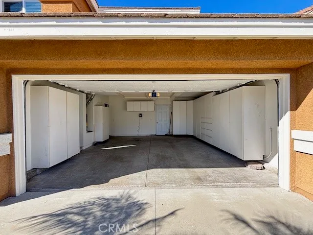 a view of garage with a dishwasher and a dresser