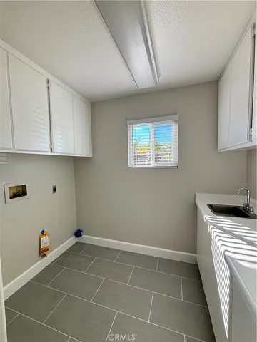 a kitchen with a sink cabinets and utility