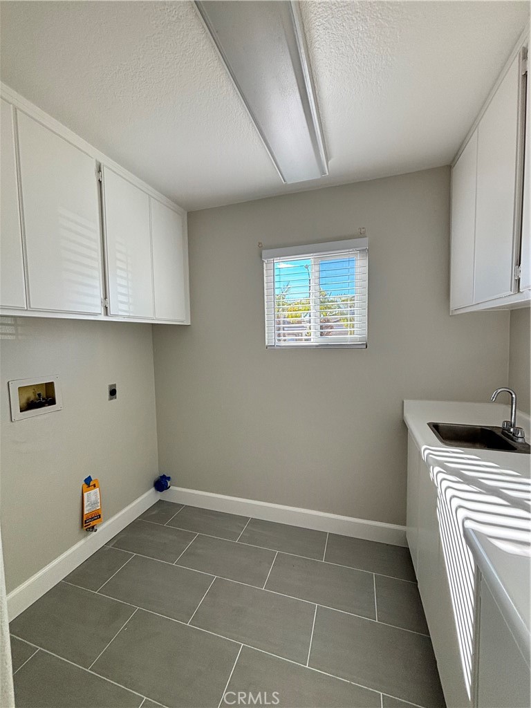 15252 Riviera Lane La Mirada, CA 90638 - Photo 6 of 18 a kitchen with a sink cabinets and utility