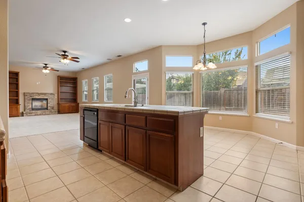 a large kitchen with kitchen island granite countertop a large counter top and stainless steel appliances