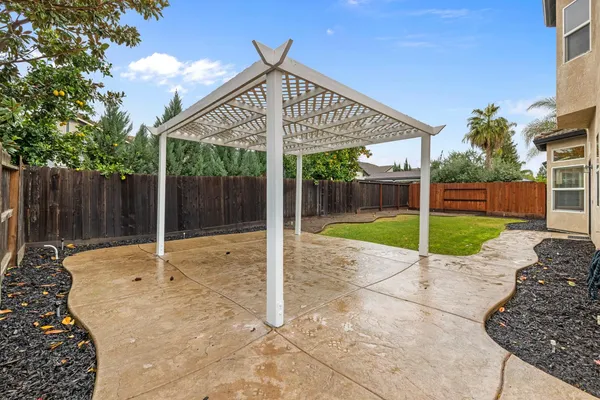 a backyard of a house with garden and outdoor seating