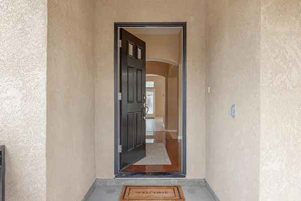a view of a hallway with a white door and a window