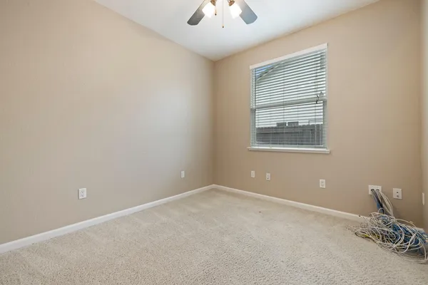 an empty room with windows and closet