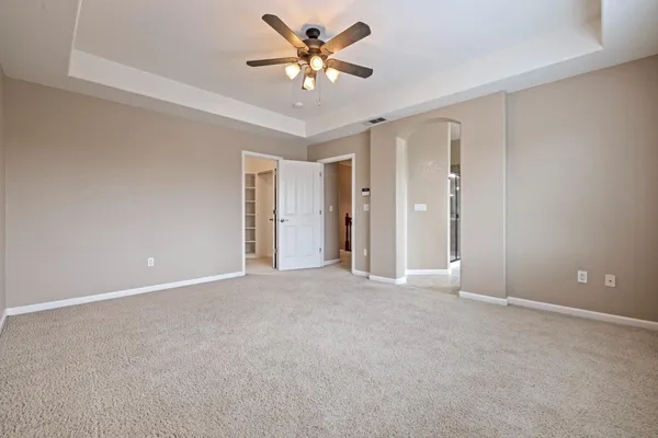 a spacious bathroom with a shower sink and mirror