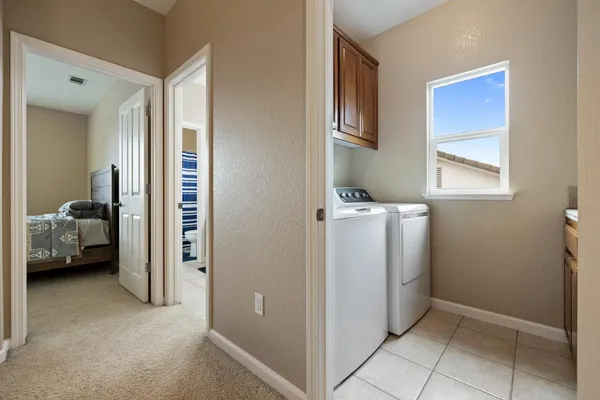 a bed sitting in a bedroom next to a window