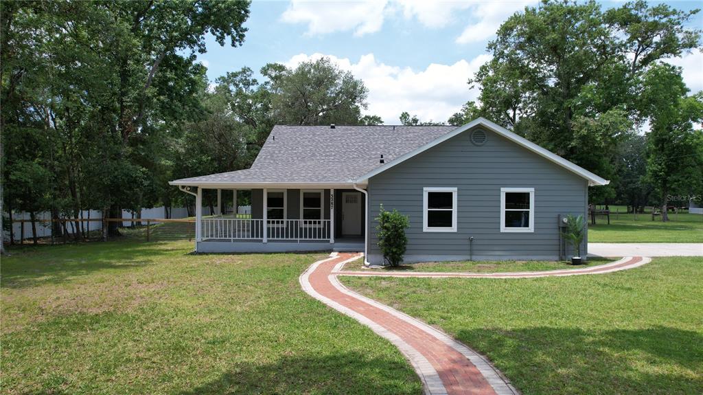 3287 Rackley Road Brooksville, FL 34604 - Photo 1 of 1 a front view of a house with garden