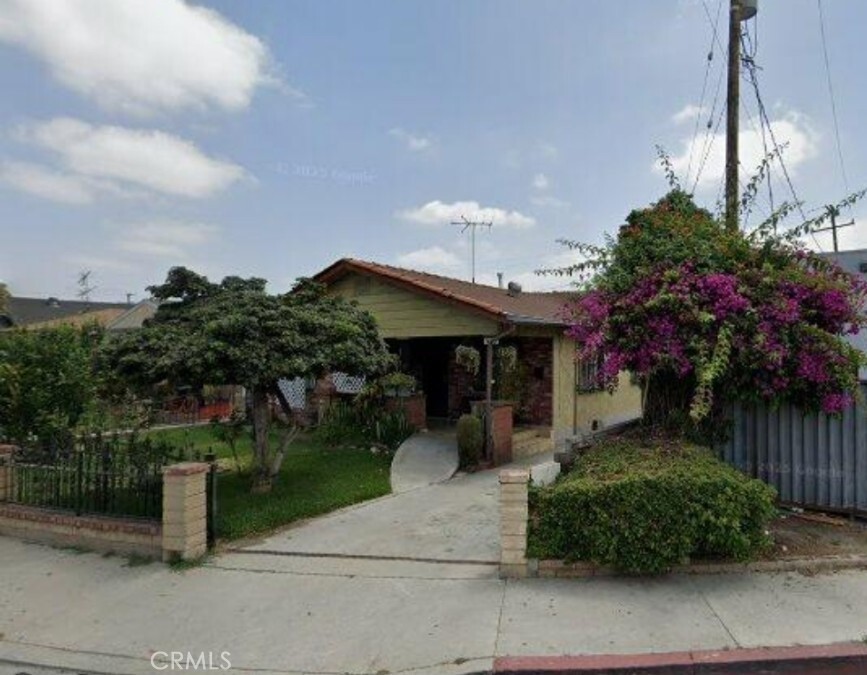 6336 Wilcox Avenue Bell, CA 90201 - Photo 1 of 1 a front view of a house with a garden