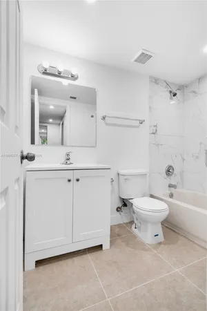 a bathroom with a toilet a sink and bathtub
