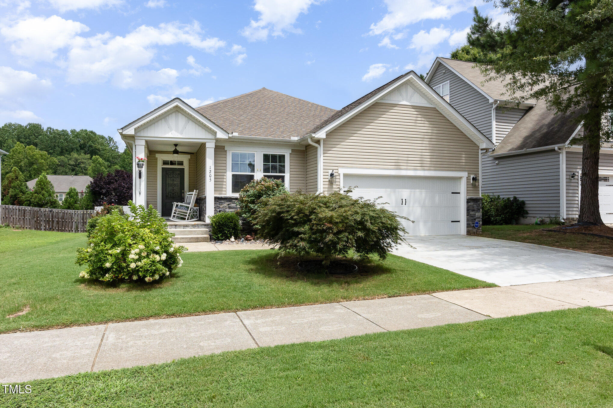 a front view of a house with a garden