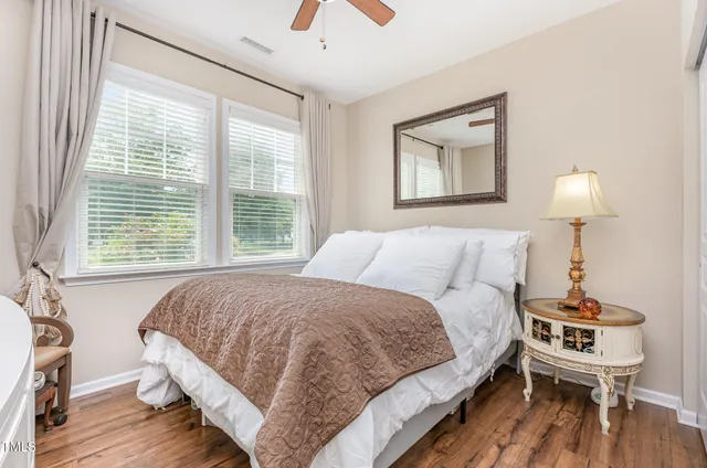 a bedroom with a bed and a night stand