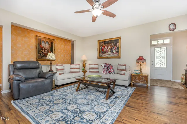 a living room with furniture and wooden floor