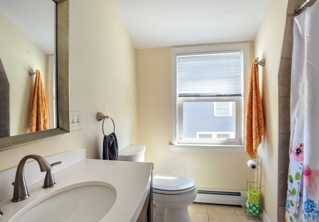 12 L Street Hull, MA 02045 - Photo 20 of 29 a bathroom with a toilet sink and mirror