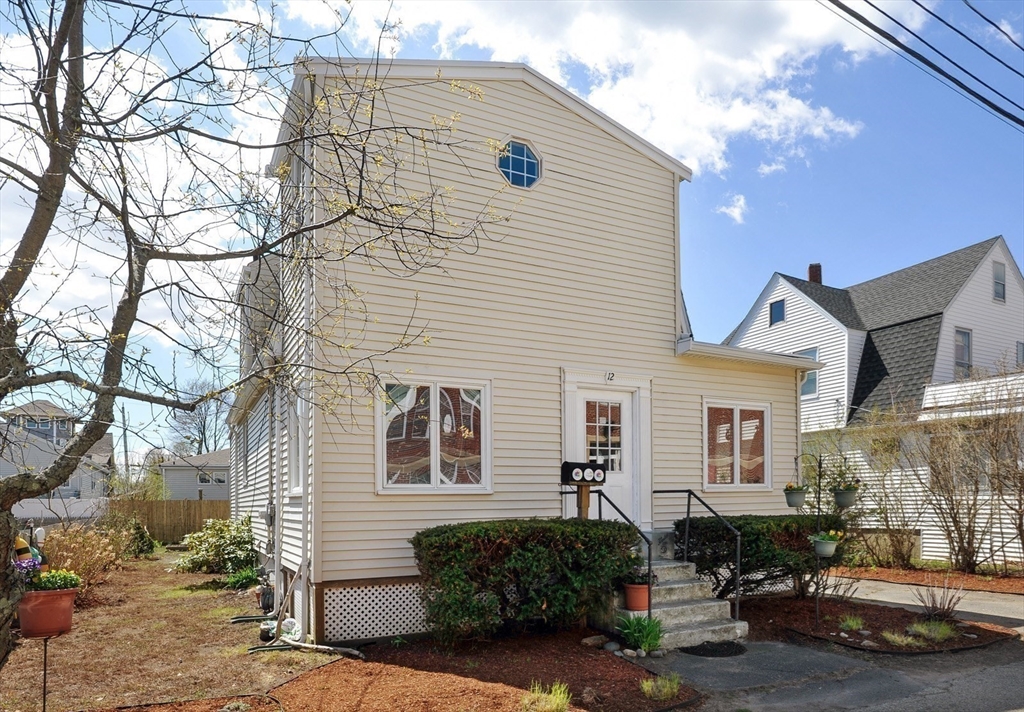 12 L Street Hull, MA 02045 - Photo 26 of 29 a front view of a house with cars parked