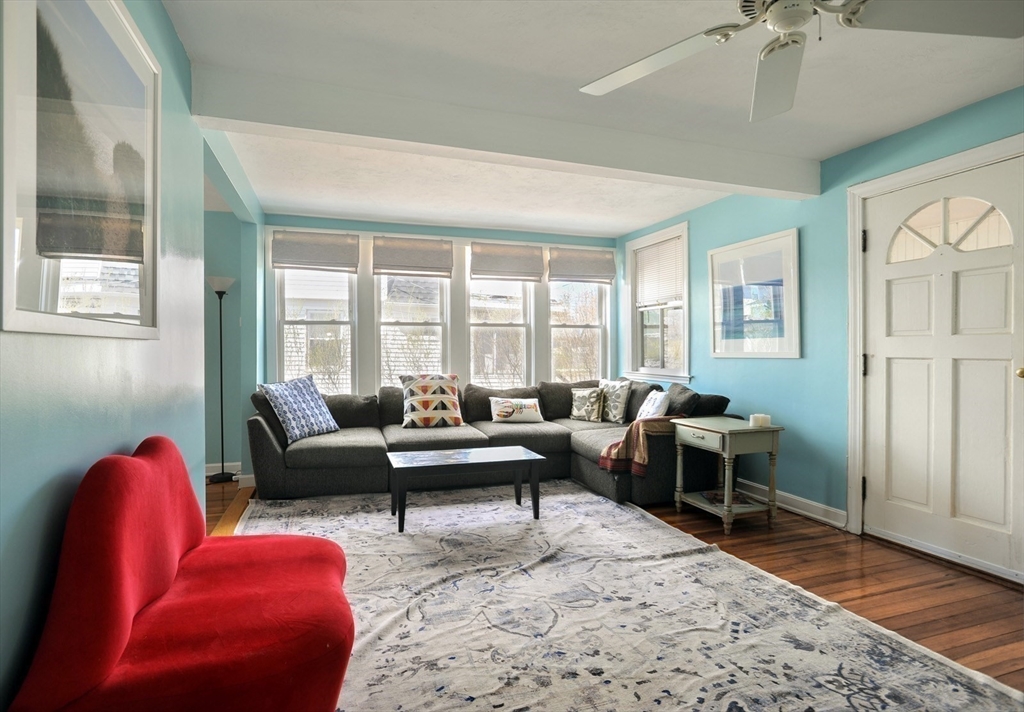 12 L Street Hull, MA 02045 - Photo 4 of 29 a living room with furniture a rug and a chandelier