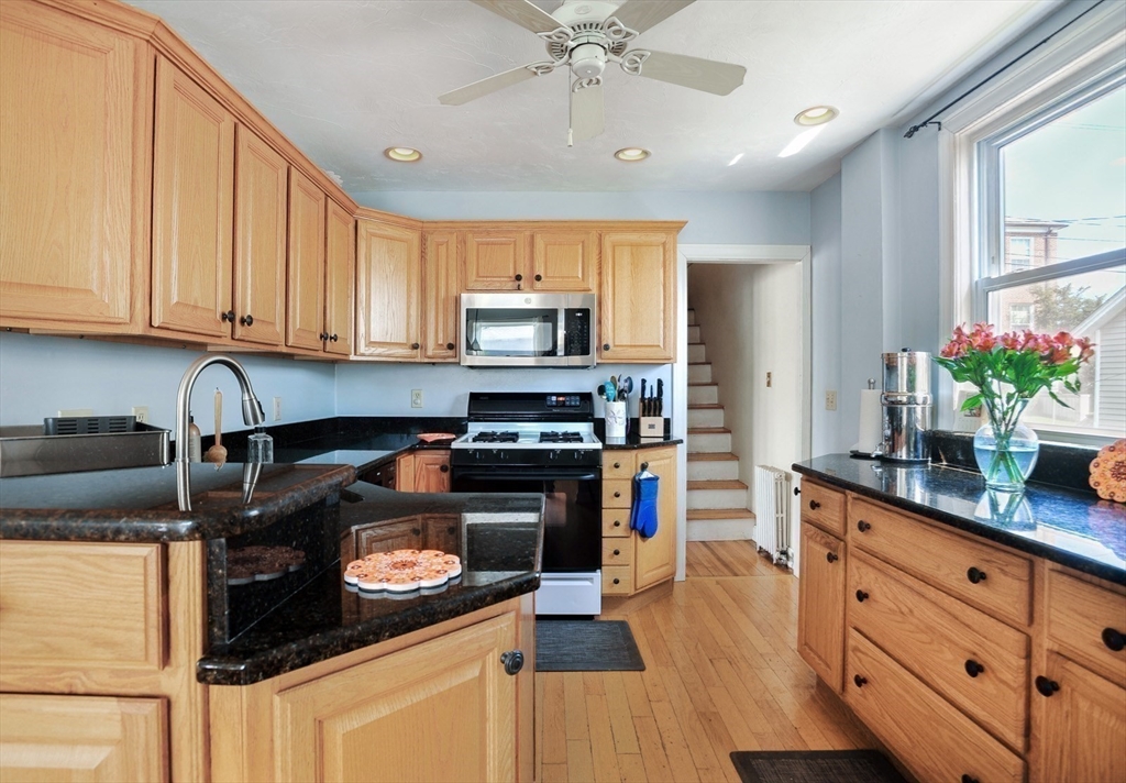 12 L Street Hull, MA 02045 - Photo 8 of 29 a kitchen with a stove a sink and a refrigerator
