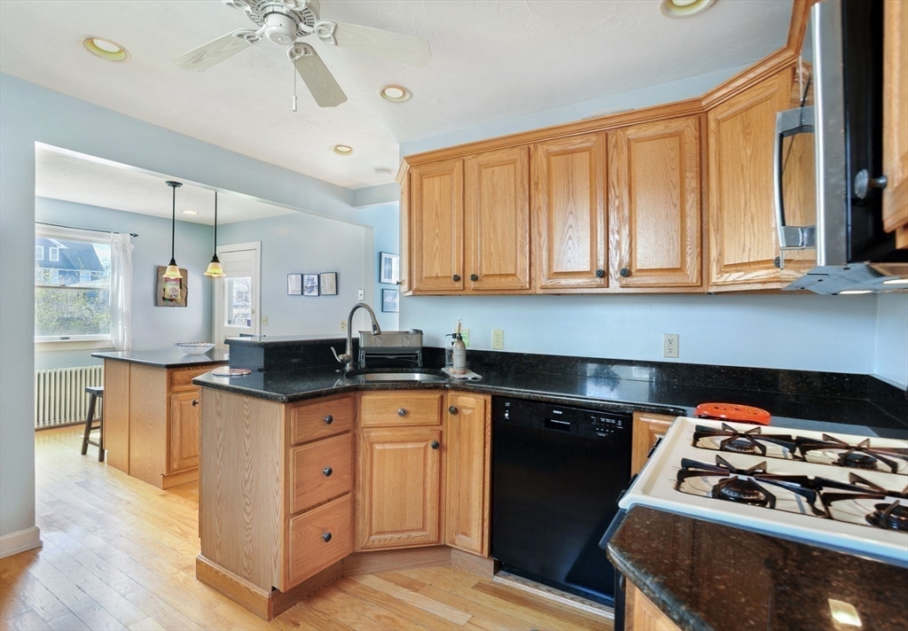 12 L Street Hull, MA 02045 - Photo 9 of 29 a kitchen with stainless steel appliances granite countertop a stove and a sink