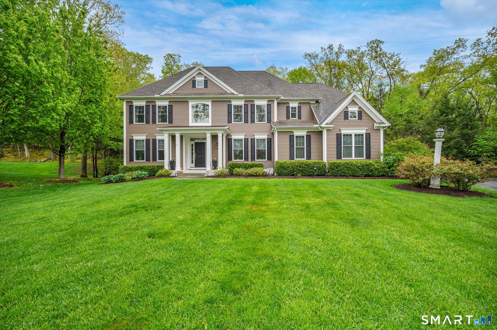 16 Sweetheart Mountain Road Canton, CT 06019 - Photo 2 of 40 a front view of a house with a garden
