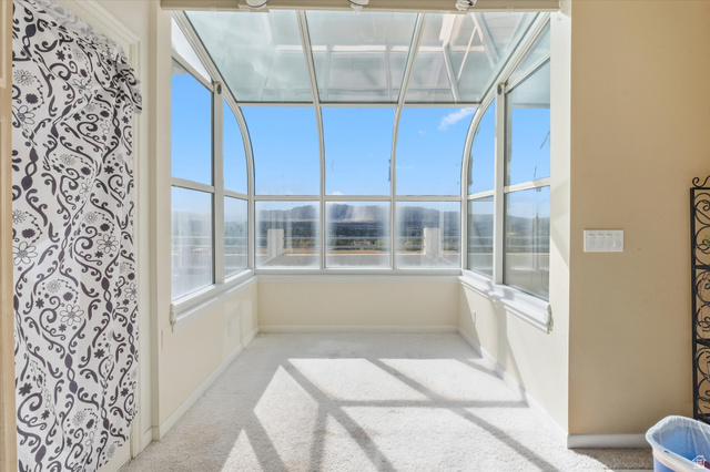 2887 View Crest Circle North Logan, UT 84341 - Photo 11 of 37 Unfurnished sunroom with healthy amount of natural light and carpet flooring