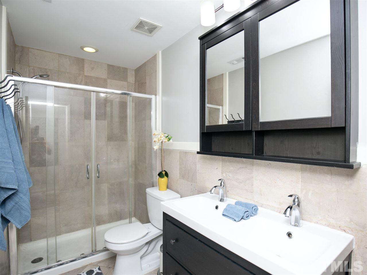 2542 Noble Road Raleigh, NC 27608 - Photo 18 of 27 a bathroom with a sink toilet and shower
