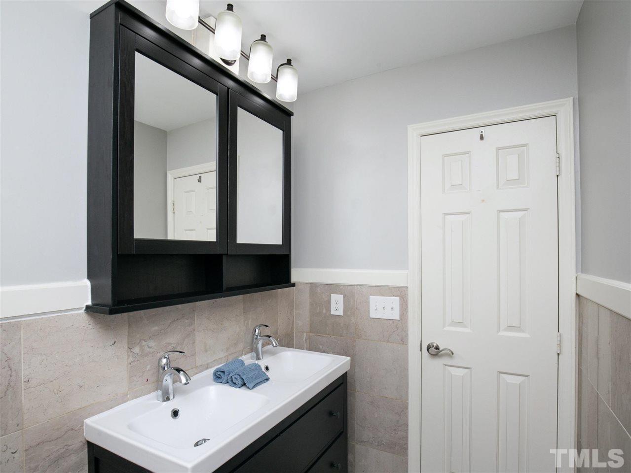 2542 Noble Road Raleigh, NC 27608 - Photo 19 of 27 a bathroom with a sink and a mirror