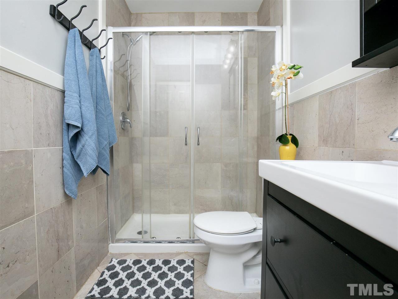 2542 Noble Road Raleigh, NC 27608 - Photo 20 of 27 a bathroom with a sink a toilet and shower