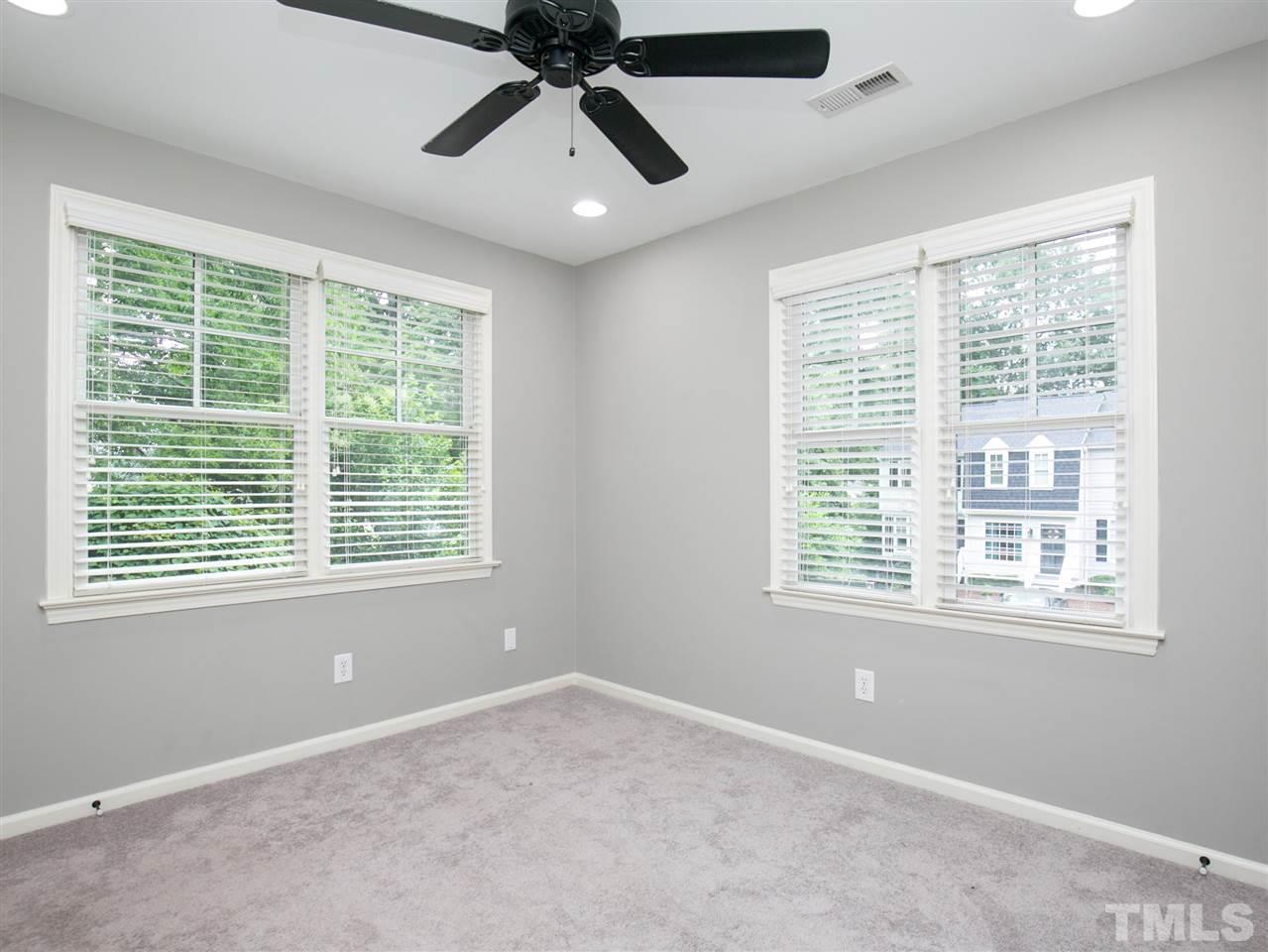 2542 Noble Road Raleigh, NC 27608 - Photo 22 of 27 an empty room with a window and a fan