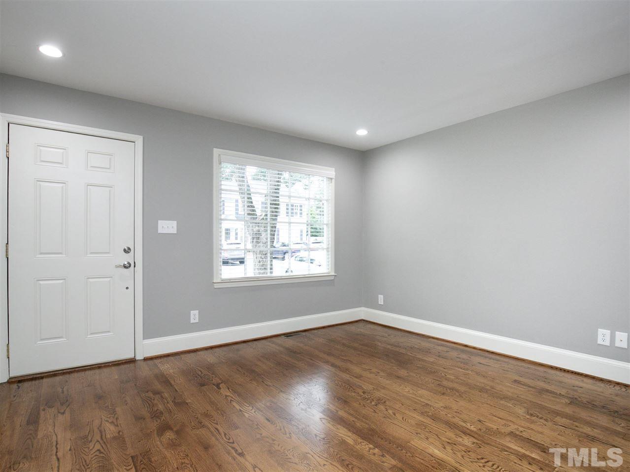 2542 Noble Road Raleigh, NC 27608 - Photo 7 of 27 wooden floor in an empty room with a window